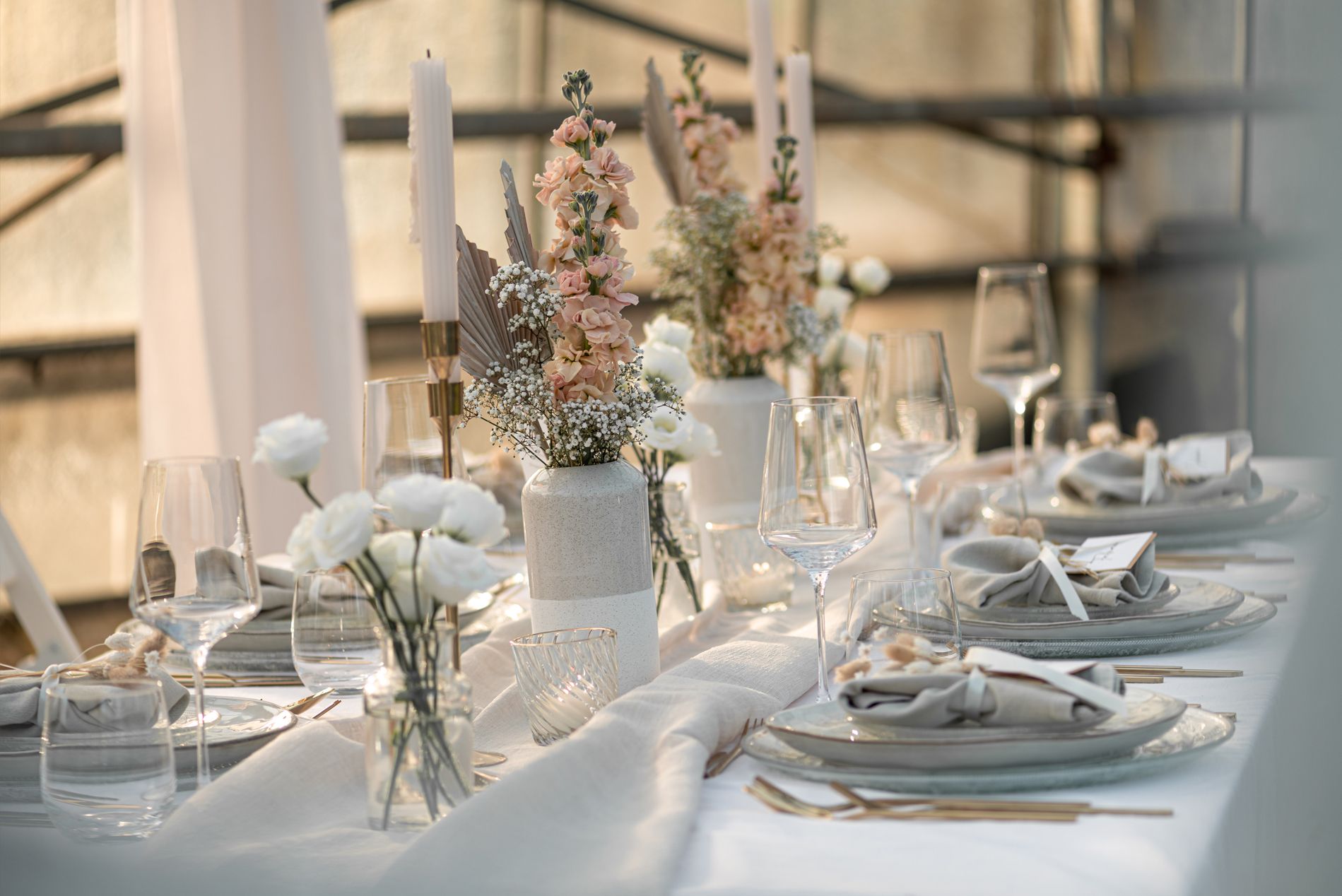 Gedeckter Tisch mit Kerzen und Blumen