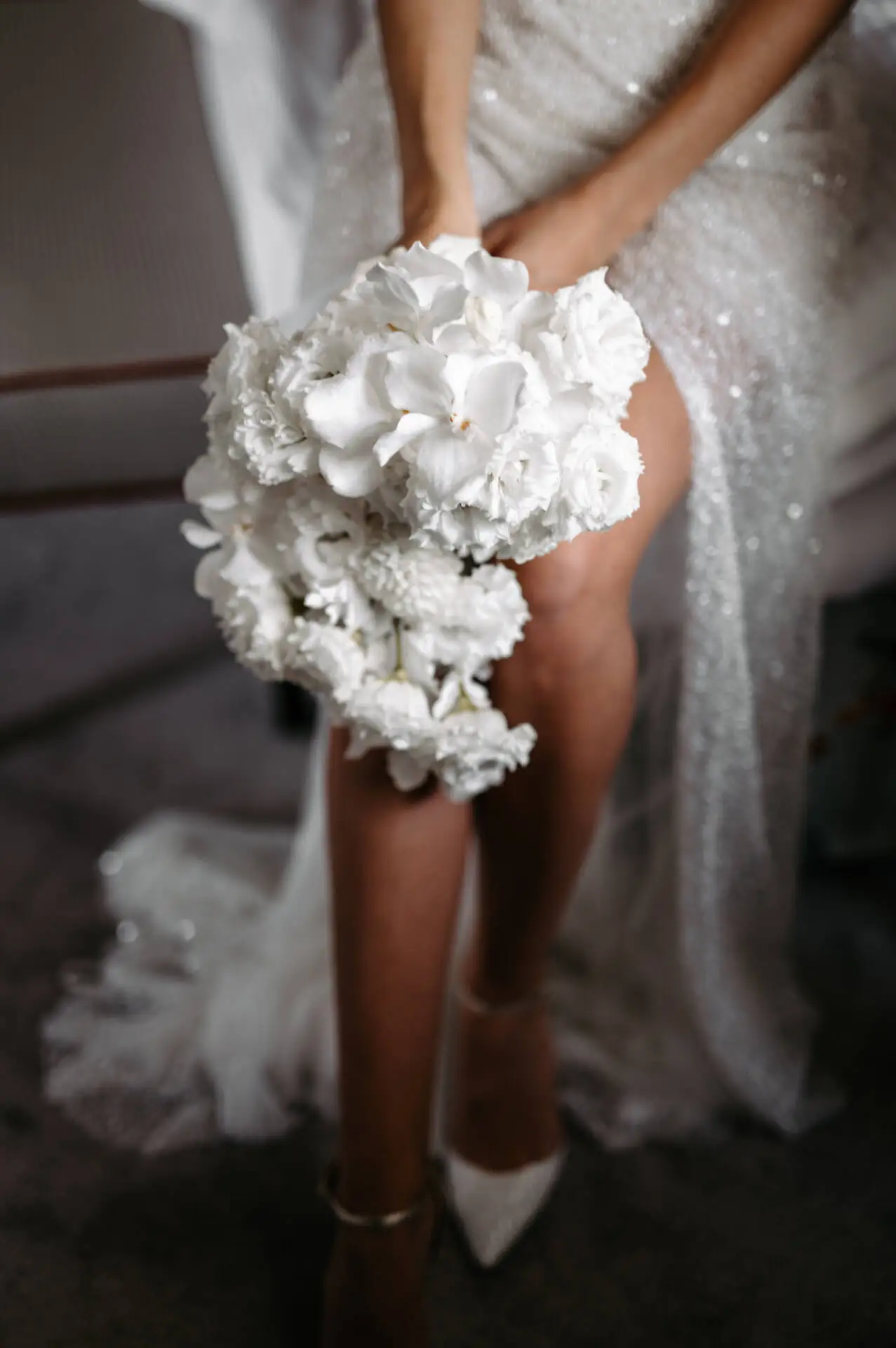 Braut hält weißen Blumenstrauß