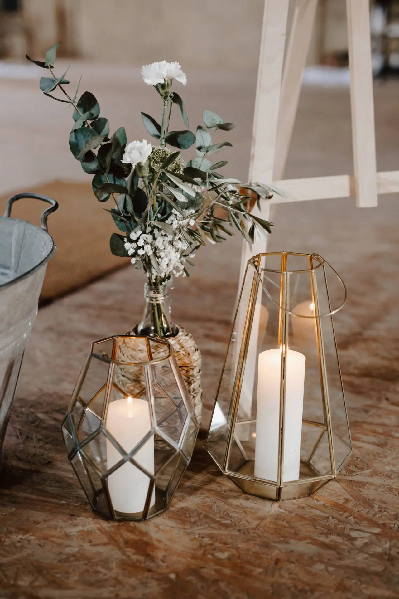 Kerzen und Blumen auf rustikalem Boden