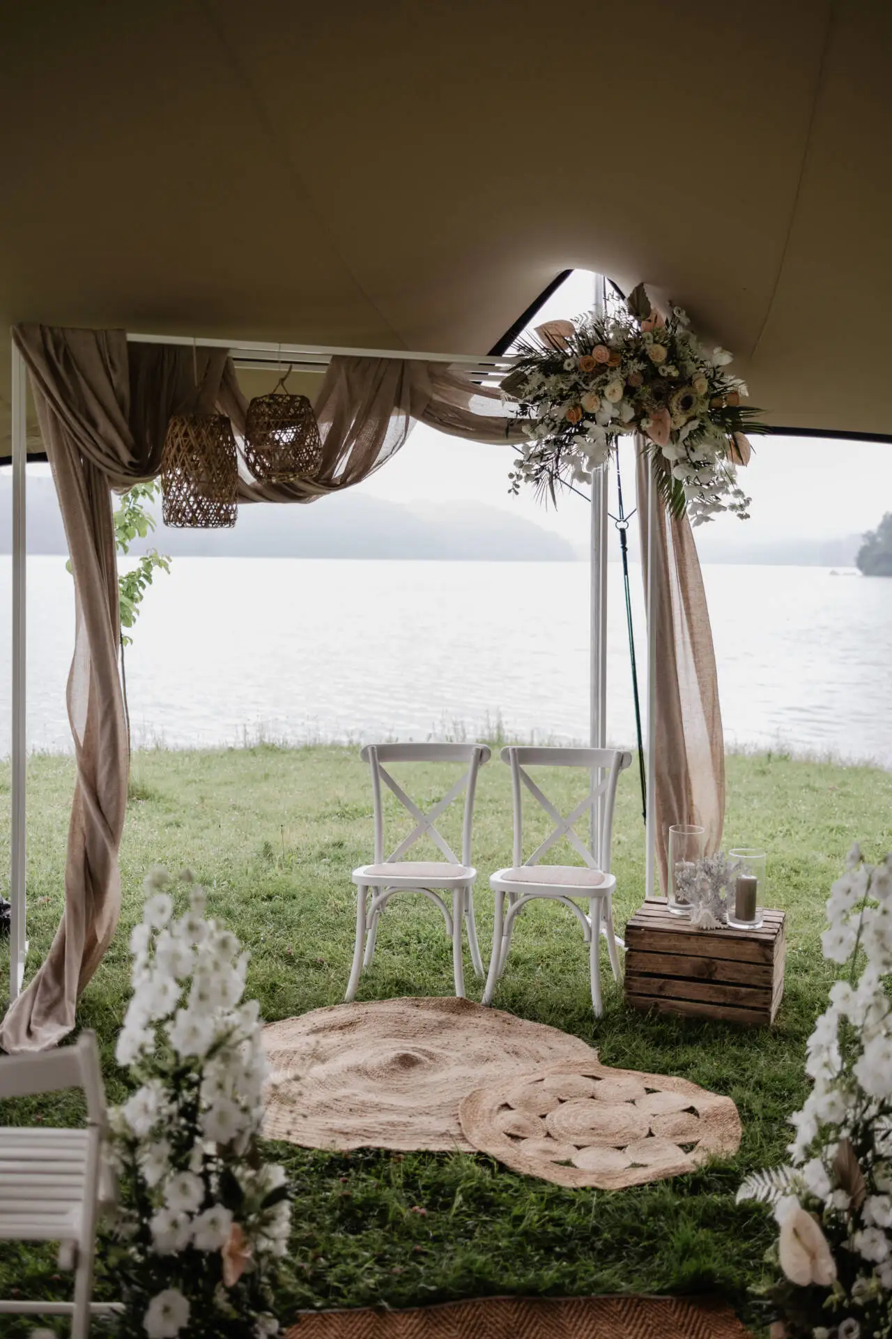 Romantische Hochzeit am See mit dekoriertem Zelt.